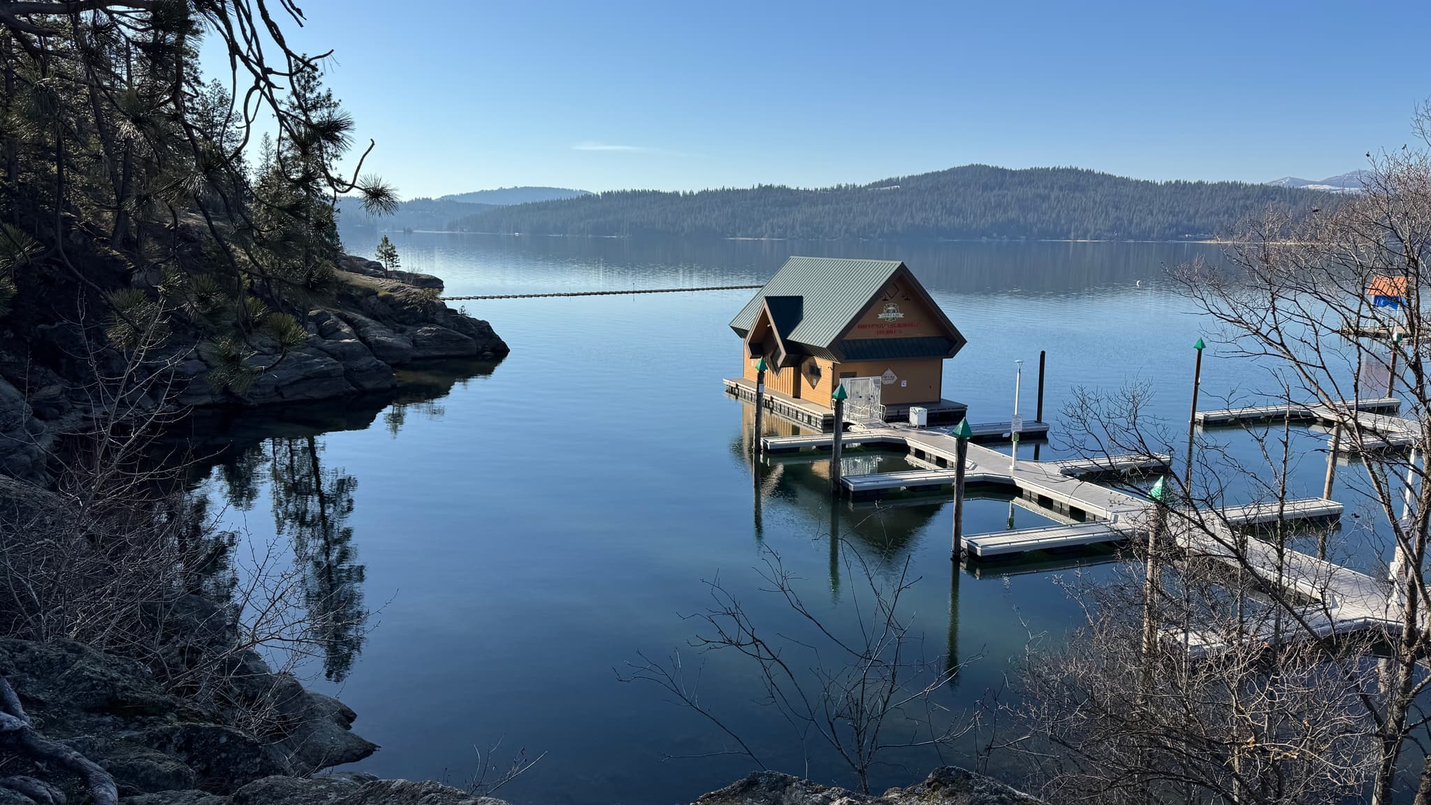 Boathouse on Lake Coeur d'Alene with calm water and surrounding Idaho landscape